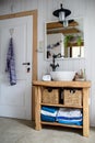 Sink, mirror and wooden cupboard in bathroom at home. Royalty Free Stock Photo