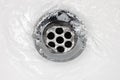 Sink plug drain hole bath plughole, white basin spout, running water macro closeup, stainless steel, china porcelain hand Royalty Free Stock Photo