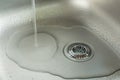 A Sink With Waterdrops, Water Jet And Chrome Drain Strainer