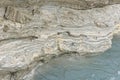 Sinkhole filled with turquoise water, near Dead Sea coastline. Leyers of mud and salt. Hole formed when underground salt Royalty Free Stock Photo