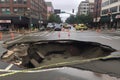 sinkhole that opened up in the middle of a busy traffic intersection