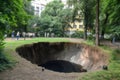 sinkhole in a park, with people enjoying the view and nature
