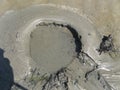 A sink hole with quicksand closeup at the beach in summer