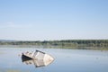 Sinking boat, an abaondoned passenger ship, rusting in the waters of the Danube river in Serbia, during summer, in a natural park.