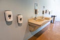 Sinks and Lots of Hand Sanitizer Dispensers on an Indoor Wall during the Covid-19 Pandemic