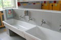 Sinks and washbasins with low taps in the toilets of a nursery