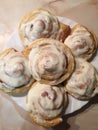 Sinnabon buns. Cinabon rolls with cream cheese on a white plate Royalty Free Stock Photo