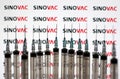 Sinovac logo and medical syringes