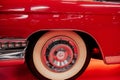 SINSHEIM, GERMANY - OCTOBER 16, 2018: Technik Museum. Left creamy colored wheel of red polished vintage automobile on