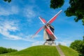 Sint-Janshuis Mill, windmill with few cloud and blue sky background in Brugge, Belgium.
