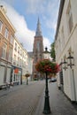 Sint Martinuskerk church, located in Wyck neighborhood, with colorful flowers and a street lamp in the foreground Royalty Free Stock Photo