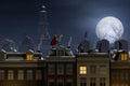 Sinterklaas and the Pieten on the rooftops at night Royalty Free Stock Photo