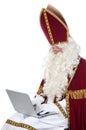 Sinterklaas using a laptop