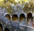 Sintra, Portugal, October 04, 2018: The girl looks down into the initiation well