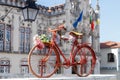 Sintra, Portugal. Old bicycle decorated with the flowers on the square in front of the Town Hall. Royalty Free Stock Photo