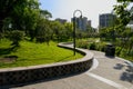 Sinuous lakeside path in verdant city on sunny summer day