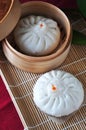 Chinese Steamed Pork Bun on Bamboo Mat Background Royalty Free Stock Photo