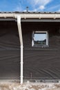 SIP panel house construction. New gray metal tile roof with white rain gutter. Royalty Free Stock Photo