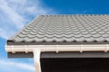 SIP panel house construction. New gray metal tile roof with white rain gutter.