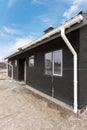 SIP panel house with new gray metal tile roof,white rain gutter and insulation. Royalty Free Stock Photo