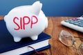 SIPP self invested personal pension written on a piggy bank