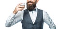 Sipping finest whiskey. Stylish rich man holding a glass of old whisky. Bearded gentleman drink cognac