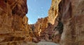 The Siq, narrow gorge, the entrance passage leading to historical and archaeological city, Petra UNESCO World Heritage Site