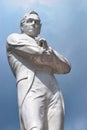 Sir Stamford Raffles statue against a dull blue sky