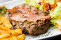 Sirloin steak with chips and bacon Royalty Free Stock Photo