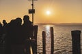 People enjoying sunset at Garda lake pier Royalty Free Stock Photo