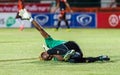 SISAKET THAILAND-MAY 24: Mfeyet Njoya Souleymane of Sisaket Utd. (green) in action during Regional League between Sisaket Utd. an