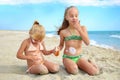 Sister applying protective sunscreen on young child. Girl draws sun cream Royalty Free Stock Photo