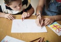 Sister and brother drawing at a table