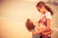 Sister and brother playing on the beach at the day time. Royalty Free Stock Photo