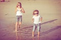 Sister and brother playing on the beach at the day time. Royalty Free Stock Photo