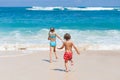 Sister and brother playing on the beach at the day time. Royalty Free Stock Photo