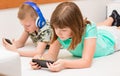 Sister and brother playing online games on smartphone