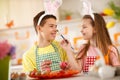 Sister and brother playing while painting Easter eggs Royalty Free Stock Photo