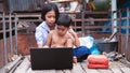 Sister and brother watching and studying online learning with laptop