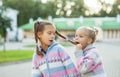 Sister dabbles and bites her braid older Royalty Free Stock Photo