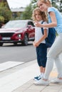 Sister explains to the boy how to cross the street safely