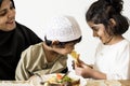 Sister feeing brother in a family dinner Royalty Free Stock Photo