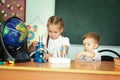 Sister are helping her little brother with his home work