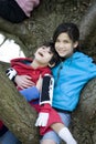 Sister holding disabled brother in tree