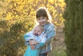 The sister is holding her little brother in her arms, the boy is crying Royalty Free Stock Photo