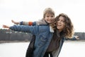 sister holds the child on top of her back, cheerfully spreading her arms and laughing Royalty Free Stock Photo