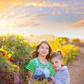 sister kid girs farmer in vineyard harvest in mediterranean autumn