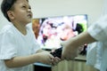 Sister, little brother fighting to get the remote control,asian sibling,aggressive kid boy and child girl fighting over the TV