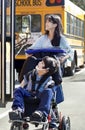 Sister pushing disabled brother in wheelchair Royalty Free Stock Photo