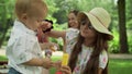 Sister taking care about small brother. Parents looking siblings in park Royalty Free Stock Photo